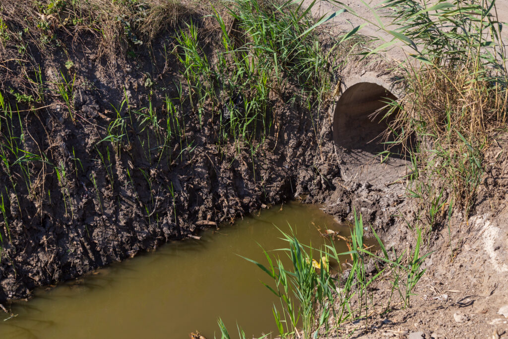 Caniveau de drainage des eaux pluviales en périphérie urbaine Caniveau de drainage des eaux pluviales en périphérie urbaine